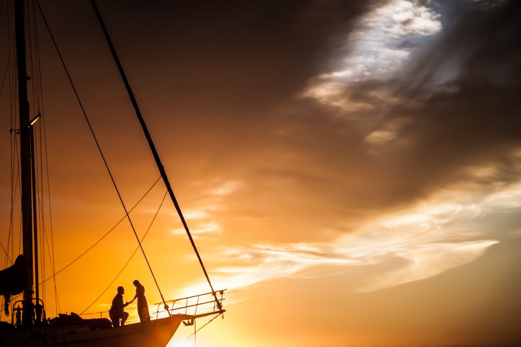 romantic wedding proposal on boat in san diego during the sunset